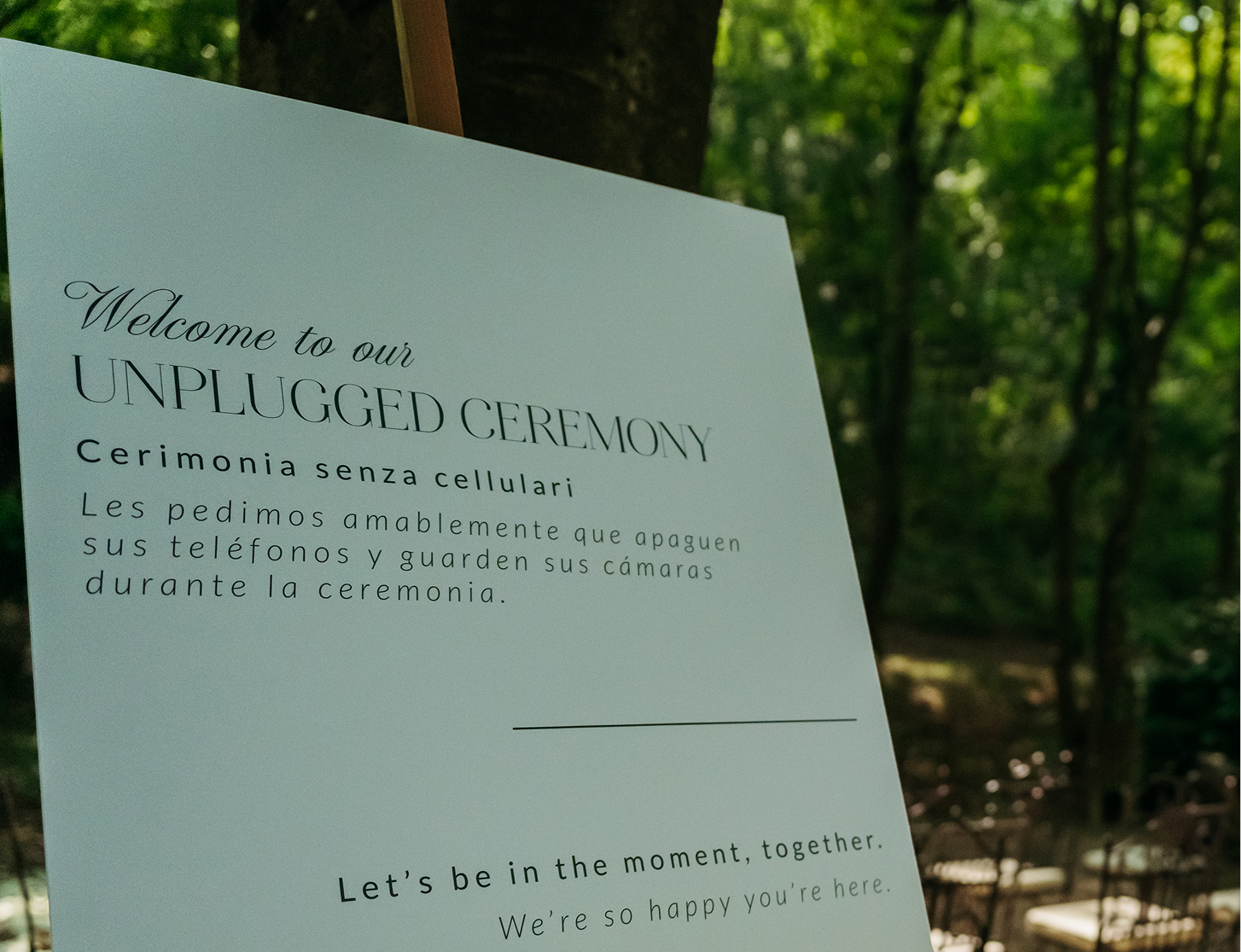 Welcome sign for an unplugged ceremony set among the trees